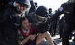 Policemen arrest a a protester during a demonstration organised from left-wing activists w...