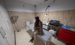 An Iranian woman waits to receive skin laser therapy at the Jelveye Mandegar specialized s...