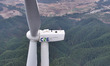 Workers perform maintenance work at the Shiiling wind farm in Daliang town, Rongan County,...