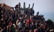 Palestinians wait to be allowed to return to their homes in northern Gaza after they are d...