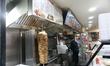 A fast food restaurant with a skewer-grilled lamb operates at night in the Pigalle distric...
