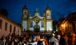 People stand in front of the Igreja Matriz de Santo Antonio (Church of Saint Anthony) in T...