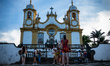 People stand in front of the Igreja Matriz de Santo Antonio (Church of Saint Anthony) in T...