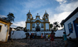 People stand in front of the Igreja Matriz de Santo Antonio (Church of Saint Anthony) in T...