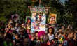 People attend the carnival celebrations with the Bloco Palhacada (Clowning Group) in Tirad...