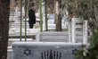 An Iranian man stands among the graves at a Jewish cemetery in southern Tehran, Iran, on F...