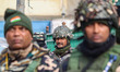 Indian paramilitary soldiers guard as Bharatiya Janata Party (BJP) leaders and supporters...