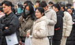 Job seekers look for jobs at a spring recruitment fair for 2025 college graduates in Huai...