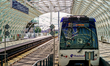 A train is at The Hague Central Station with a bus terminal in The Hague, South Holland, H...