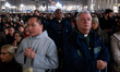 A priest holds a rosary at St Peter's Basilica before prayers for the health of Pope Franc...