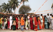 Hindu devotees queue outside a temple with their offerings during the Maha Shivaratri fest...