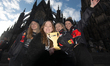Carnival revelers pose for pictures in front of Cologne Cathedral at the start of the carn...