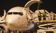 Staff members load cargo into the cabin at Huaian Lianshui International Airport in Huai'a...