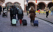 Rolling suitcases on cobblestones make a lot of noise. Tourists in the old city of Freibur...