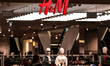 Consumers walk in front of H&M shop in Galeria Krakowska shopping mall in central Krakow,...