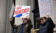 Over 100 U.S. postal workers and supporters gather on the steps of the James A. Farley pos...