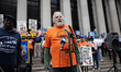 Over 100 U.S. postal workers and supporters gather on the steps of the James A. Farley pos...