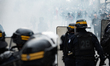 CRS riot police officers use tear gas against demonstrators during a demonstration in Pari...