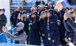 The Italian ski team and staff members sing the Italian national anthem during the women's...
