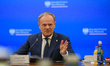 Polish Prime Minister Donald Tusk gestures as he speaks during a meeting with the entrepre...