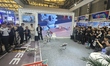 Visitors view the UNITREE G1 humanoid robot and Go2 Quadruped robot (robot dog) at 2025AWE...