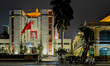 The Hanoi Municipal People's Committee headquarters is illuminated at night with a portrai...