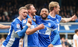 #25, Ben Davies (center left) receives congratulations for his goal during the Sky Bet Lea...