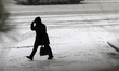A pedestrian walks near the transit terminal as heavy snow falls in Brampton, Ontario, on...