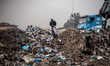 Palestinian youths search for salvageable items to reuse in a garbage dump that sprawls ac...
