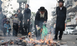Ultra-Orthodox Jews pray and burn leavened bread in the Mea Shearim neighborhood of Jerusa...