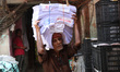 A worker carries Bengali calendars ahead of the Bengali New Year in Kolkata, India, on Apr...