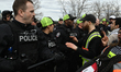 EDMONTON, CANADA - APRIL 13 Members of the Edmonton Police attempt to push protesters off...