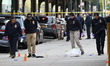 NYPD crime scene unit investigators photograph the area and mark the shell casings and oth...