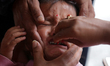 A Nepali child receives the polio drop at an immunization center in Kathmandu, Nepal, on A...