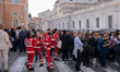 People wait in line outside St. Peter's Basilica to view the body of Pope Francis in Rome,...