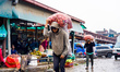 A porter carries overloaded vegetables at a vegetable market in Kathmandu, Nepal, on May 1...