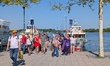 Groups of visitors leave passenger boats at piers 4 and 5 on the lakeside promenade of Pri...