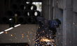An Iranian worker works at the Kerman steel and rolling complex in Khazra industrial city...