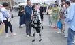 Tourists interact with the Unitree G1 humanoid robot at the International Coffee Culture F...