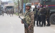 Security forces guard the street near the Wuyan area of Pampore in south Kashmir, where a...
