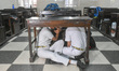 School children duck under desks following a mock drill protocol announced by the Central...