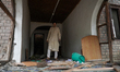 People assess a damaged residential house in Uri town, Baramulla district, north of Srinag...