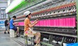 A worker works in a workshop of a textile products manufacturing enterprise in Qingzhou Ec...