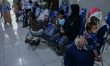 Dozens of patients with disabilities queue for health services at the disability posyandu...
