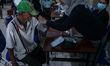 A nurse checks the blood pressure of an elderly patient at a disability posyandu in Poleha...