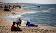 Palestinians spend time on the Mediterranean Sea beach during the hot weather in Gaza City...