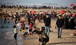 Palestinians spend time on the Mediterranean Sea beach during the hot weather in Gaza City...