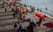 Palestinians spend time on the Mediterranean Sea beach during the hot weather in Gaza City...