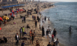 Palestinians spend time on the Mediterranean Sea beach during the hot weather in Gaza City...