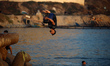 Palestinians jump into the Mediterranean Sea during the hot weather in Gaza City, on May 9...